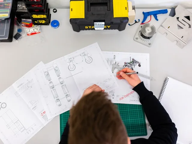 Engineer reviewing production data on a factory shop floor