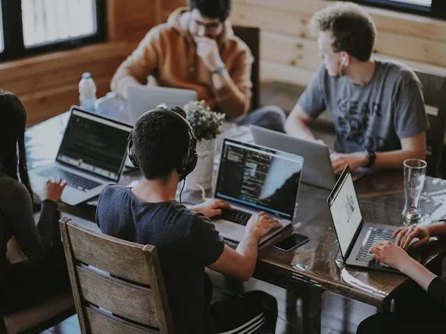Services team collaborating around a desk in an office